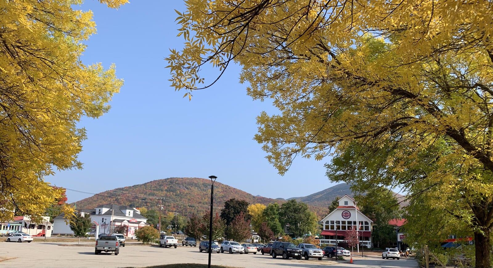 Downtown Lincoln main street with fall foliage and mountain backdrop